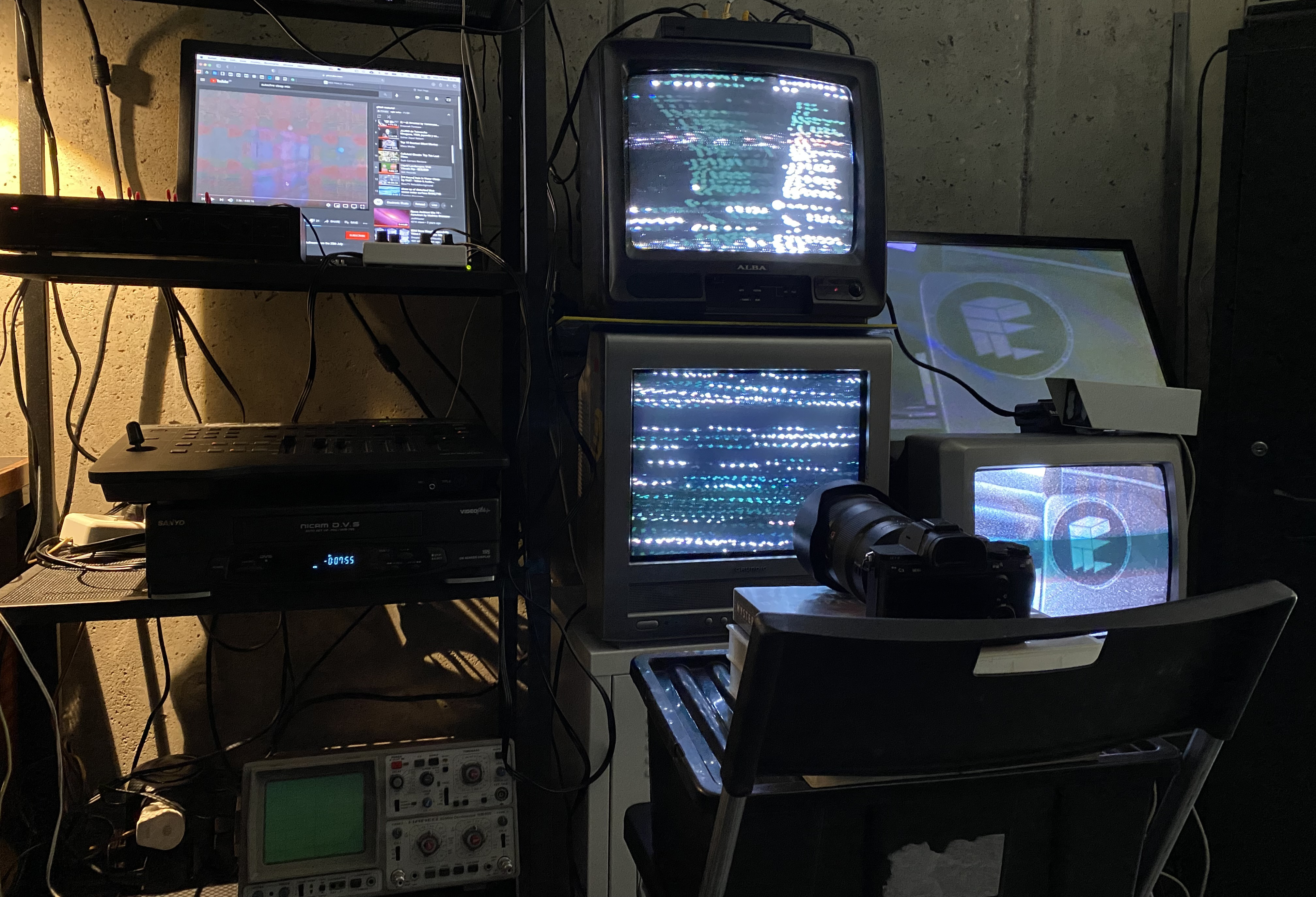 Production setup with stacked CRT screens, playback equipment and a camera